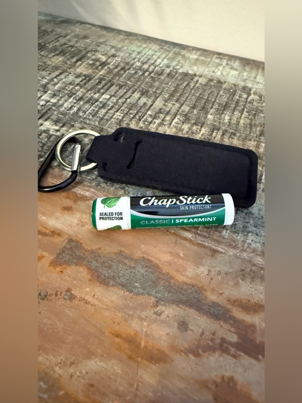 Chapstick black holder keychain.  New. Sealed chapstick included